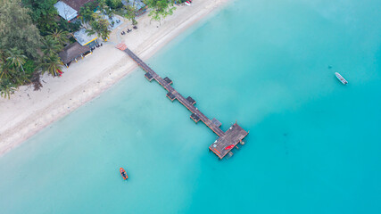 A wooden pier bridge that stretches into the sea on Koh Mak, Thailand.