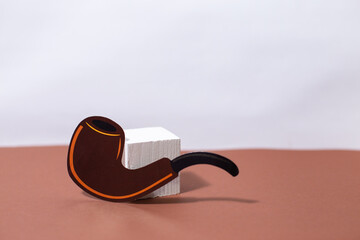 Paper smoking pipe on a brown background