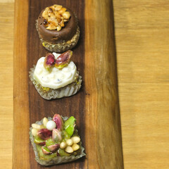 Small sweet bites, arranged on a wooden board