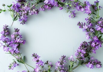 Delicate purple flowers arranged in a wreath on a soft white background are ideal for design and creative projects.