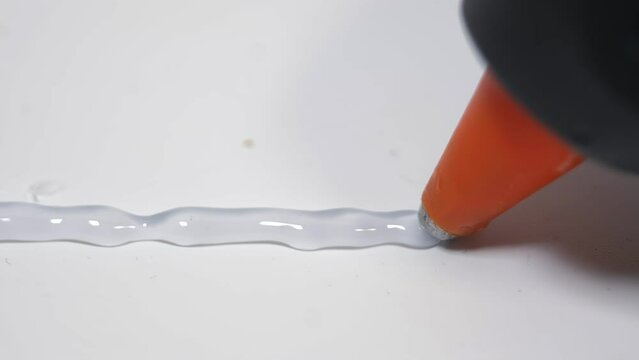 hot glue gun, applying hot glue, apartment renovation, construction, builder using hot glue gun