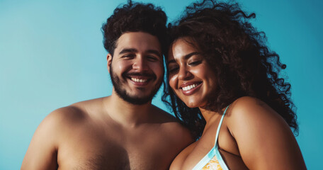 Young black couple in love on beach vacation, man and woman wearing swimsuits and smiling