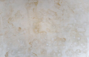 Textured background of rough uneven surface of old stone wall with cracks