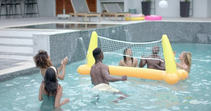 Diverse group enjoys a playful game in a pool