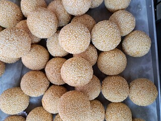 A traditional Indonesian snack made from sticky rice flour is known as Onde-onde. This snack is round like small balls filled with sweet crushed green beans and sprinkled with sesame seeds.