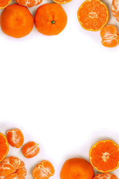 Fresh mandarin oranges on a white background with space for text. Top view, flat lay