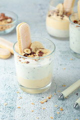 Milk mousse dessert with nuts in glasses	