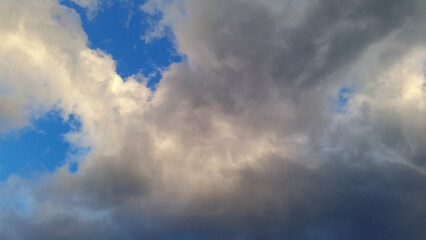 Blue sky with dark clouds