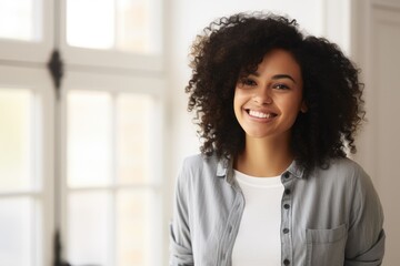 Fototapeta premium Beautiful Mixed Race Woman Smiling Candidly, Enjoying Carefree Moment Indoors