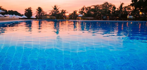 sunset in the swimming pool, closeup of a pool in a luxury hotel at sunset