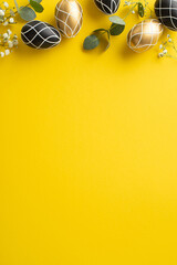 Easter luxury defined. Top view vertical photograph of opulent black and gold eggs, eucalyptus...