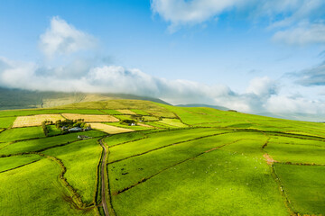Aerial view of endless lush pastures and farmlands of Ireland's Dingle Peninsula. Irish countryside...
