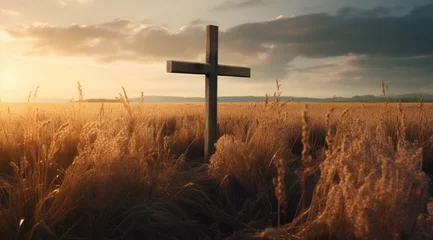 Deurstickers the cross standing in front of a field of grass © yganko
