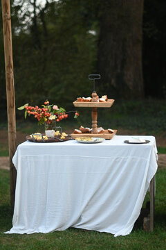 outdoors pristine Table With White Cloth with finger food for aperitive over in location venue park
