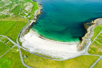 Aerial view of sandy Kilmurvey Beach on Inishmore, the largest of the Aran Islands in Galway Bay, Ireland. - obrazy, fototapety, plakaty