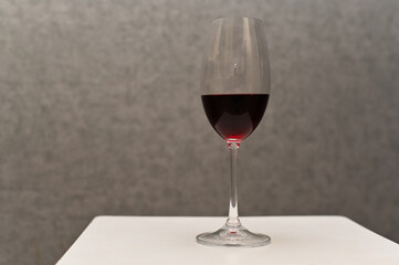 red wine in a glass. close-up on a gray background