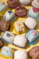 Set of different colourful macaroons on yellow background. Sweet food delicious.