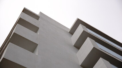 low angle of white minimalist building facade against sky