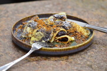 potato dough, filled with prune jam, sprinkled with poppy seeds and gingerbread, a traditional...