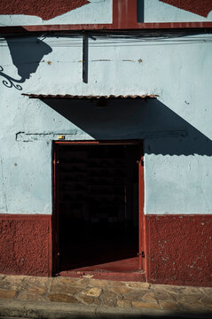 Open Doorway on Sunlit Historical Street, Shadow Play, Morning Ambience in Mexico