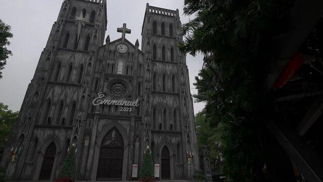 St. Joseph's cathedral in Hanoi, revealed from behind a large christmas tree.