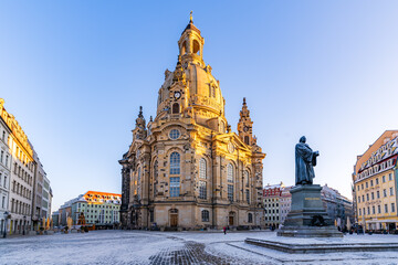 The Dresden Frauenkirche and the Luther Monument early in the winter morning light up by the...