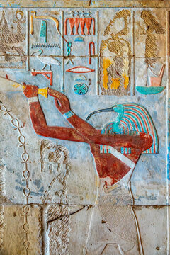Carving with colorful hieroglyphs and Thoth with a ibis head, interior of Karnak temple in Luxor, Egypt. Thoth is the Egyptian god of writing, magic, wisdom, and the moon.