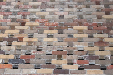 Permeable recycled brick wall laid in a pattern to allow for ventilation and light to flow through...
