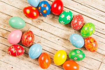 Obraz na płótnie Canvas Colorful easter eggs on wooden background