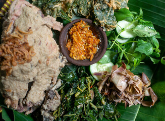 Ingkung Ayam, a traditional food from Yogyakarta, Indonesia, with spicy sauce and vegetables