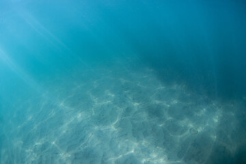 Beautiful view of light pattern on the sand underwater.