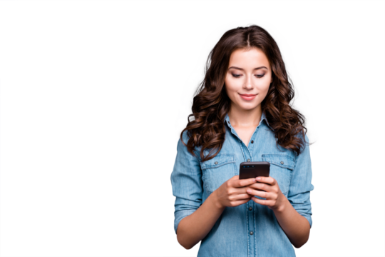 Content calm trendy nice cute adorable lovely attractive brunette caucasian girl with wavy hair in casual denim shirt, playing game in phone, isolated over grey background - Powered by Adobe