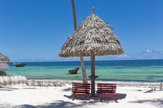 Chair and green trees on a white sand beach. Watamu, Kenya - Africa.