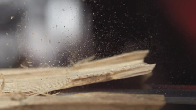 Delve into the world of woodworking as a chisel meticulously carves wood in slow motion, highlighting the art of precision.
