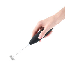 Woman holding black milk frother wand on white background, closeup