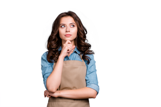 Nice cute stylish pensive lovely sweet attractive brunette girl, barista with wavy hair in casual denim shirt and apron, planning, fantasizing, isolated over grey background - Powered by Adobe