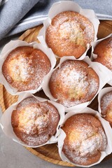 Delicious muffins on grey table, top view