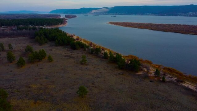 Autumn Tapestry Aerial Views of Russia Nature Drone Footage Over Volga River, Forest, and Mountains. Grushinsky Festival Meadow in Warm Glow
