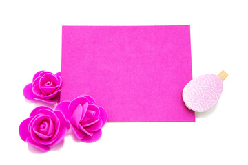 Pink blank greeting card with rose flowers with colored eggs. Copy space. Free space for text. Happy easter!	