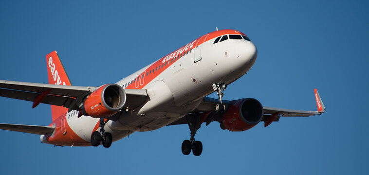 Tenerife, Spain February 18 st, 2024. Airbus A320-214 easyJet Airlines flies in the blue sky. Landing at Tenerife Airport