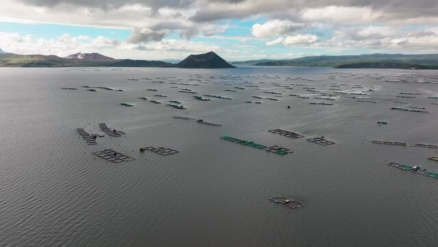 Many Fishing Cages on Taal Lake in Philippines during cloudy day. Aerial birds eye shot.