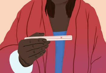 Woman holding a positive pregnancy test
