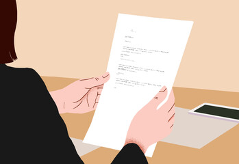 Businesswoman reading a document at her desk