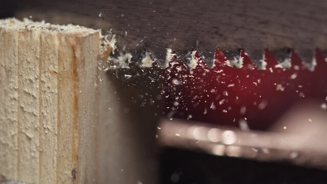 Enjoy the serene simplicity of woodworking as a hand saw glides through wood in slow motion. Lose yourself in the calming rhythm of each precise cut, a gentle reminder of the beauty found in craftsman