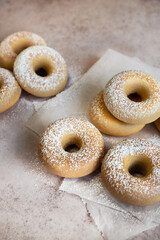 Group of baked donuts covered with powdered sugar high angle view vertical image