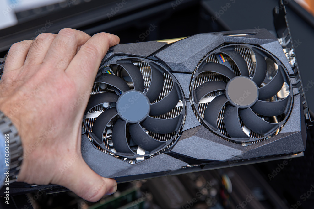 Aufkleber installing a powerful graphics card into a computer.