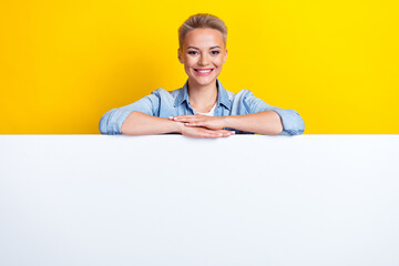 Photo portrait of attractive young woman lean on white empty space dressed stylish denim clothes isolated on yellow color background