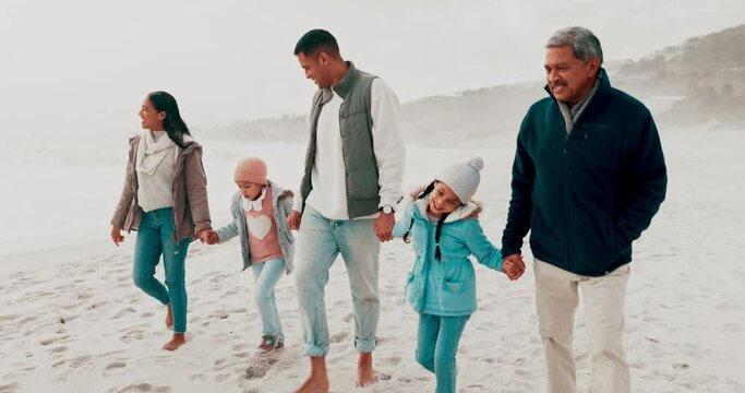 Beach, holding hands and family with children in nature for holiday, vacation and adventure in winter. Grandparents, travel and mother, father and kids for bonding, walking and relax together by sea