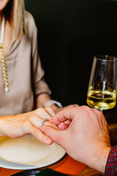 Romantic marriage proposal at elegant dinner