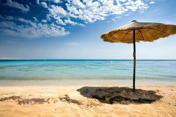 Tropical beach with umbrella, empty beach without people